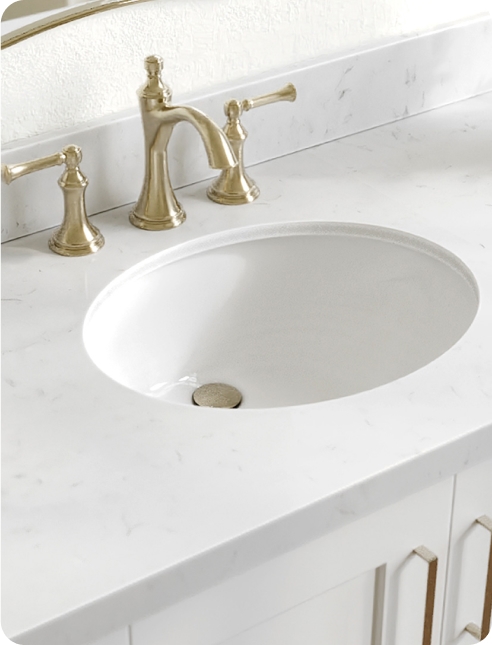Countertops Close-up of a white quartz countertop with an undermount sink and black faucet set.
