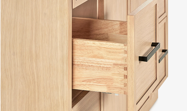 Detail of solid wood dovetail drawer partially open, showing craftsmanship and grain of American white oak.