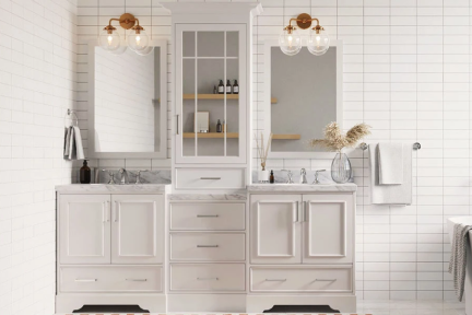 Double vanity set with central tower cabinet, white top, and chrome hardware, styled with twin mirrors and tile wall.